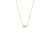 A two pearl necklace featuring two lustrous pearls on a delicate chain, creating a timeless and elegant jewelry piece.